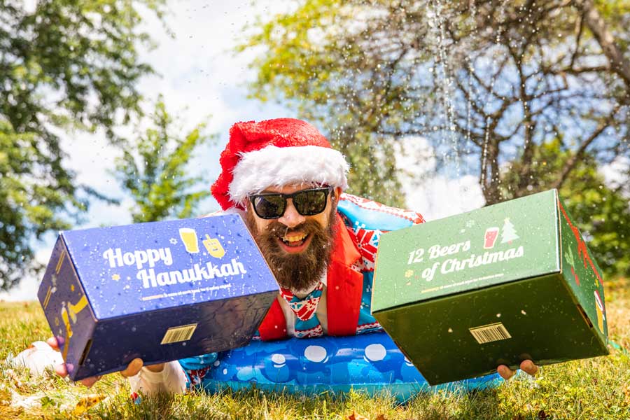 a man on a slip and slide with beer boxes
